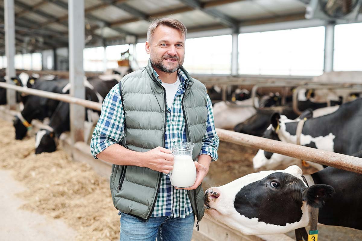 happy-young-worker-of-dairy-farm-holding-jug-with-resize.jpg
